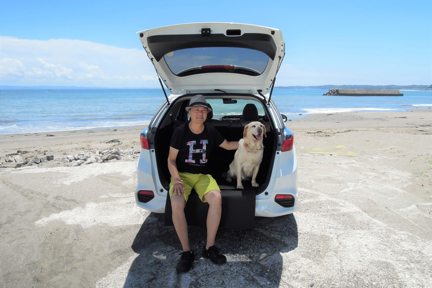 砂浜に駐車したクルマと筆者の青山尚暉さん 〜 画像5